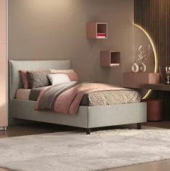 Letto una piazza e mezza in tessuto imbottito con vano contenitore disponibile in 5 colori